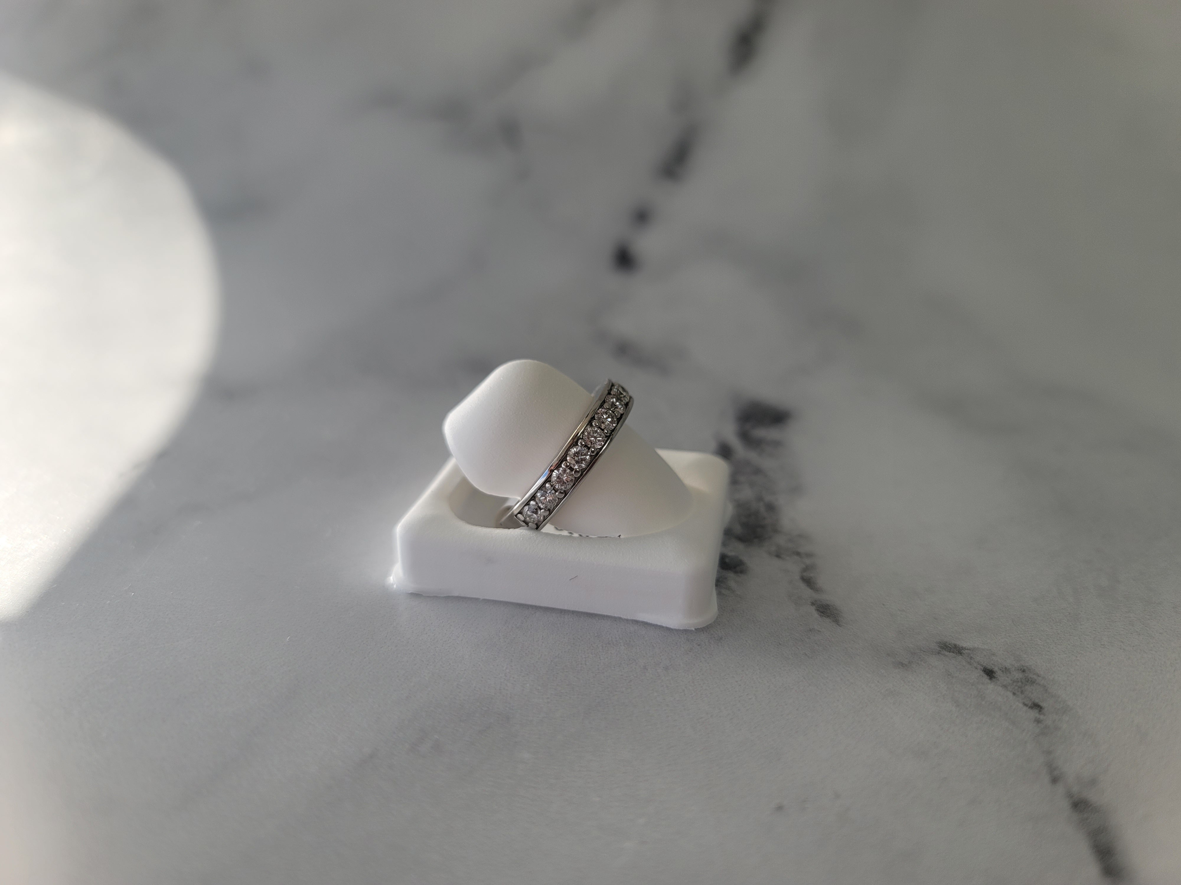 Alianza de boda con diamantes engastados en canal de un quilate en oro blanco de 14 k