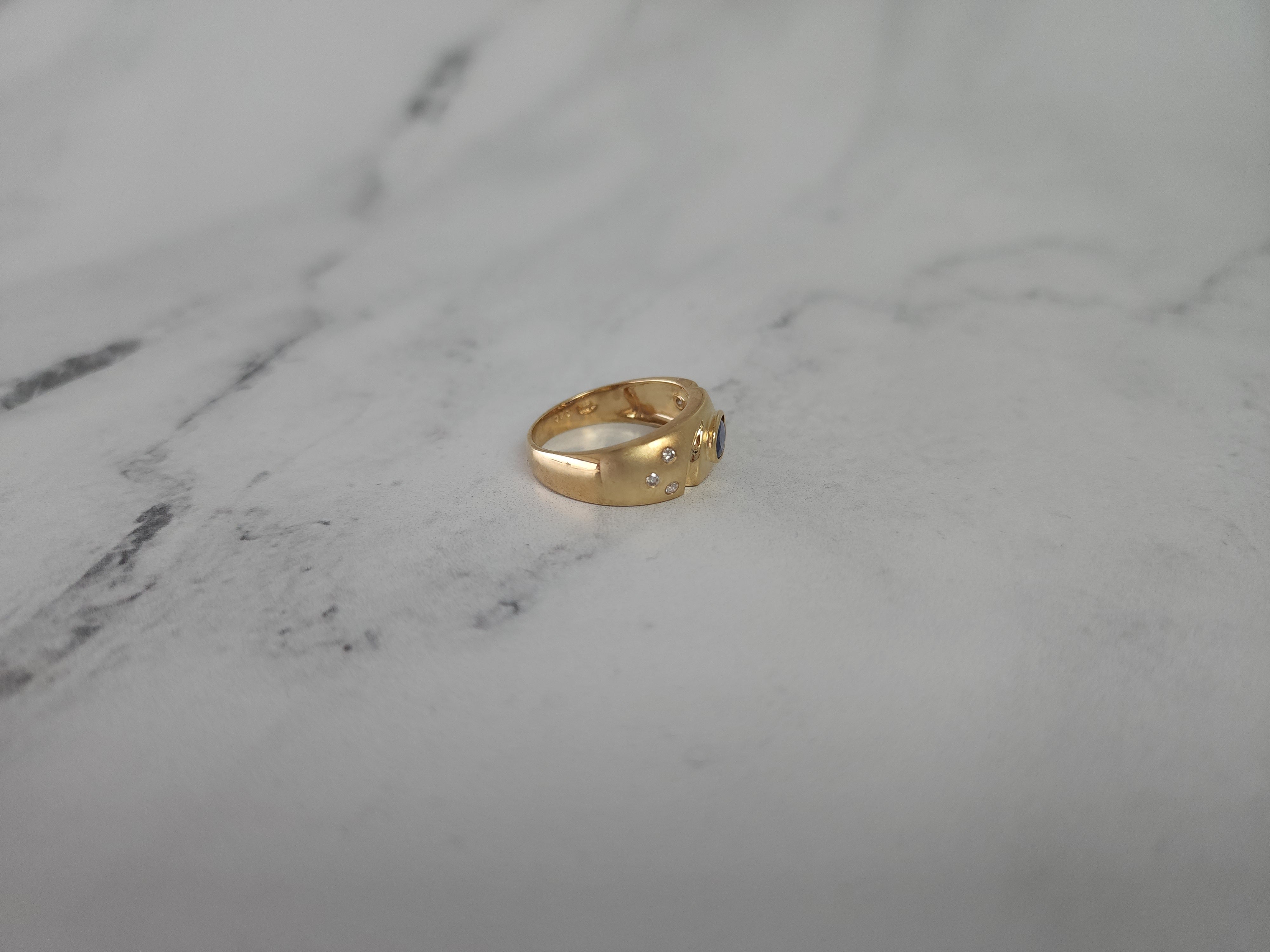 Banda de zafiro ovalado con detalles de diamantes en oro amarillo de 14 k