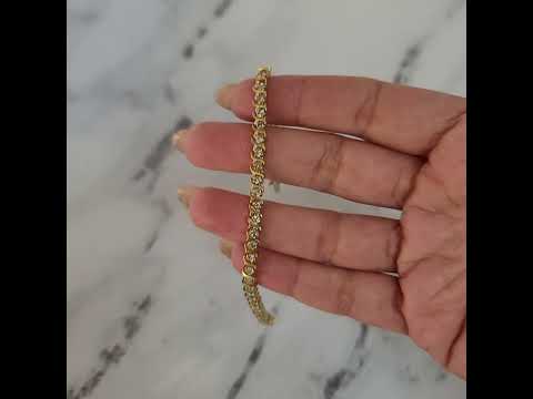 A 3 carat S style tennis bracelet made of 14k yellow gold, with round cut diamonds.